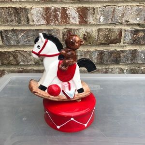 Little bear on a carousel horse music box